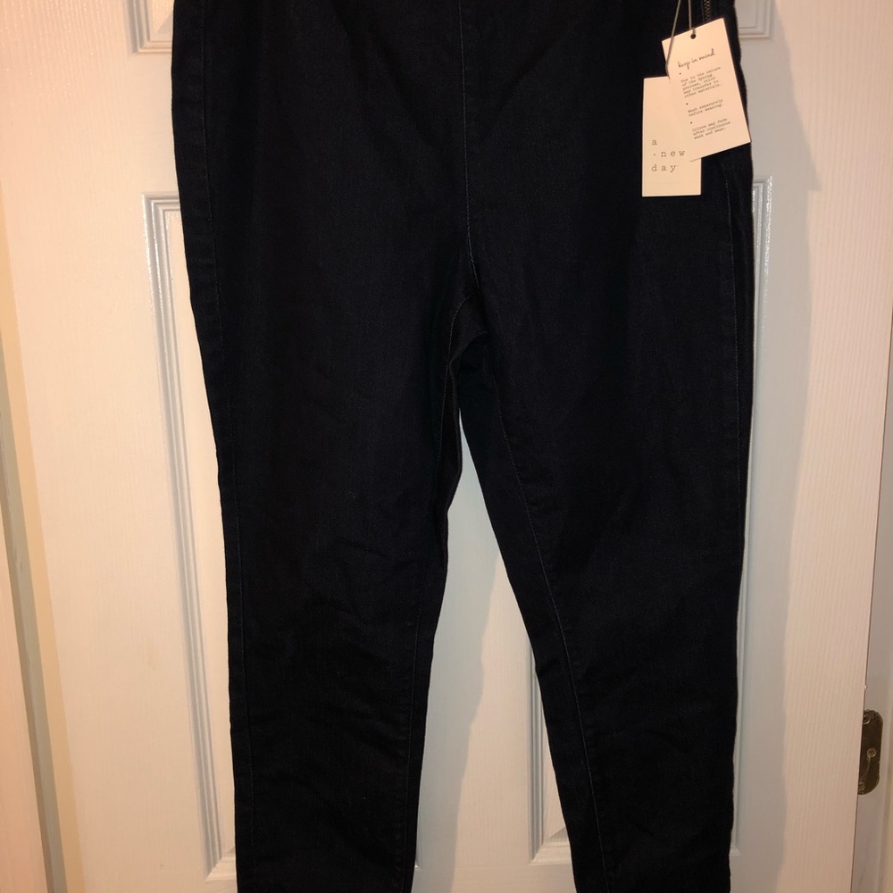 Dark blue tapered leg denim pants.